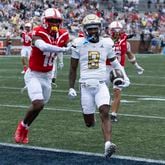 Georgia Tech wide receiver Malik Rutherford (8) runs in for a touchdown as Virginia Military Institute cornerback Asa Locks (16) defends after a catch during the first half of a NCAA college football game Saturday, Sept. 14, 2024, in Atlanta. The Jackets cruised 59-7. (AP Photo/John Bazemore)