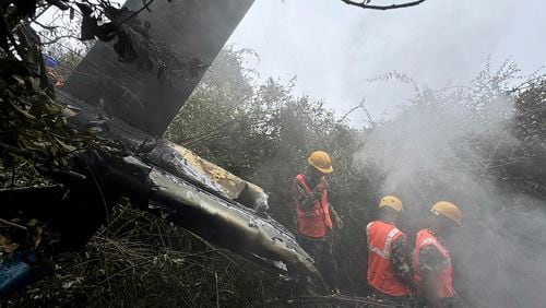 Rescuers work at the site of a helicopter that crashed in Suryachaur area, which is just northwest of Kathmandu, Nepal, Wednesday, Aug. 7, 2024. (AP Photo/Nirajan Shrestha)