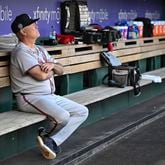 Atlanta Braves manager Brian Snitker sits alone in the dugout before a baseball game against the Washington Nationals, Wednesday, Sept. 11, 2024, in Washington. The Braves lost 5-1. (AP Photo/John McDonnell)