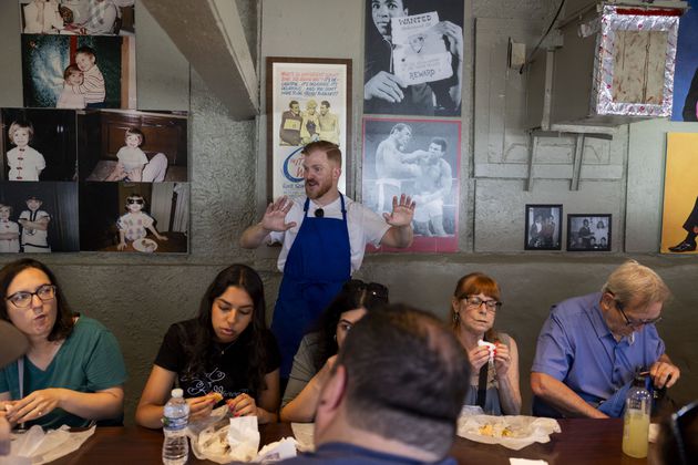 Forrest Beals, center, eats chicken dumplings at Time Out Market in Chicago during a “The Bear” themed food tour on June 21, 2024. (Vincent Alban/Chicago Tribune/TNS)