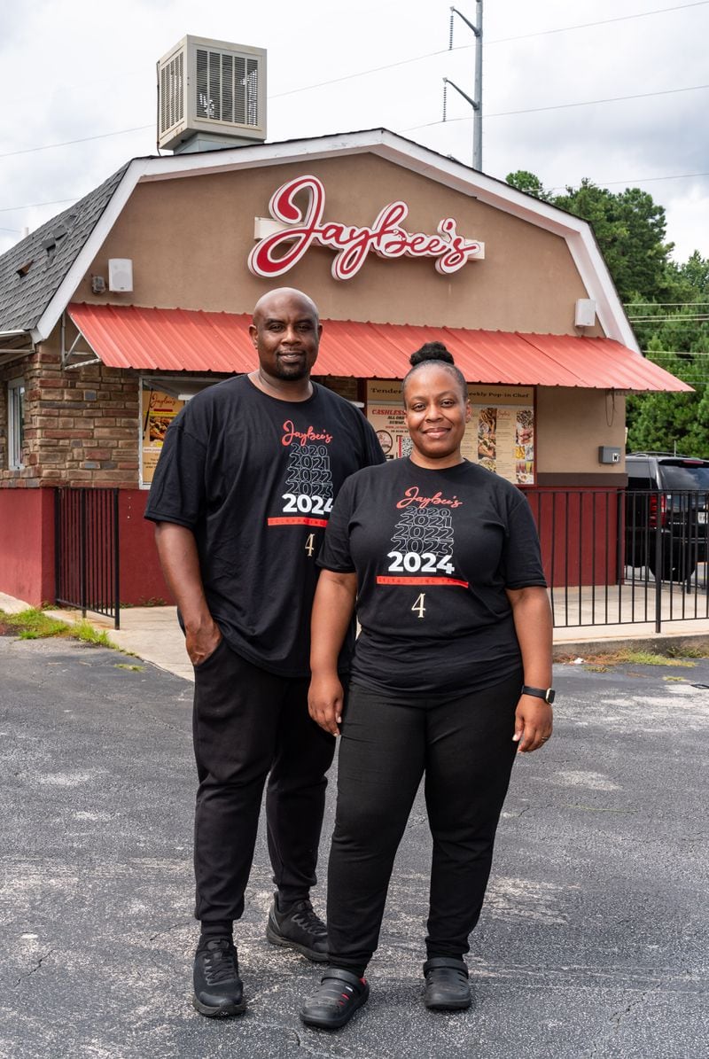 Jaybee’s Tenders co-founders Erika Harrington and her husband William Harrington pose for a portrait outside the restaurant in Decatur, GA on Thursday, July 25, 2024. (Seeger Gray / AJC)