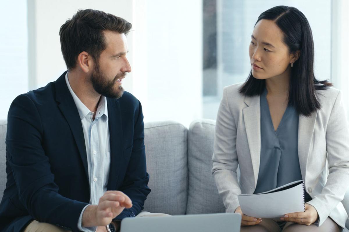 Two people in professional attire in conversation