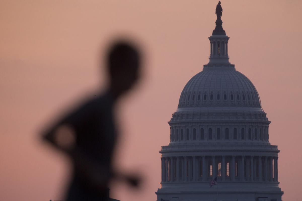 A man jogs past the U.S. Capitol 