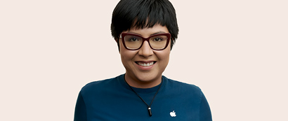 Portrait of a smiling Apple Retail team member with short, dark blond hair.