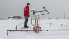 Sandra Grassl, observatory engineer at AWIPEV checks instruments of the Atmospheric Observatory.