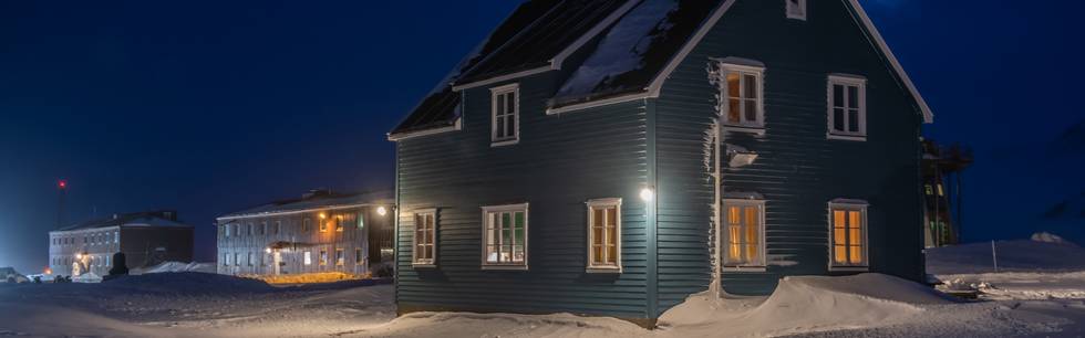 Blue House of AWIPEV in Ny-Ålesund, Svalbard during polar night. 