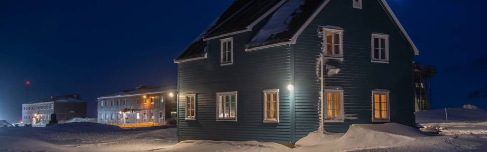 Blue House of AWIPEV in Ny-Ålesund, Svalbard during polar night. 