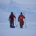 Two people cross country skiing in the snow