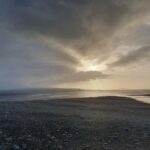 A group of clouds in the sky on a beach