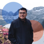 A man standing in front of a snow covered mountain