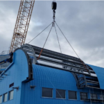 A crane next to a large blue building