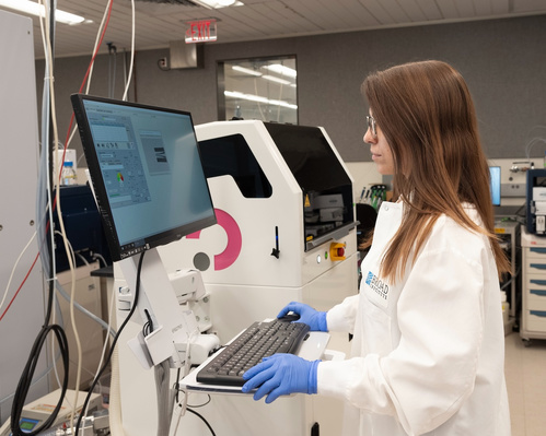 Claudia Ctortecka working with lab equipment.