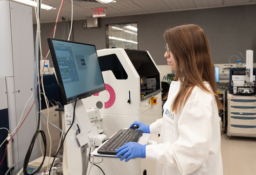 Claudia Ctortecka working with lab equipment.