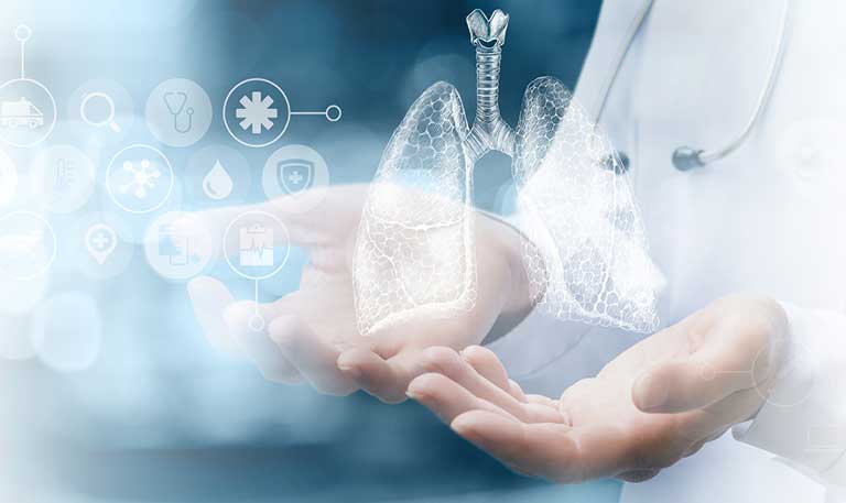 Hands holding graphics of lungs and medical symbols