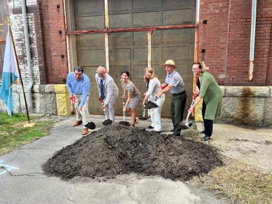 Group of 6 digging shovels into dirt