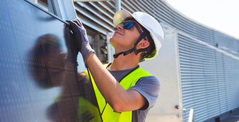 Construction worker mounting a solar panel