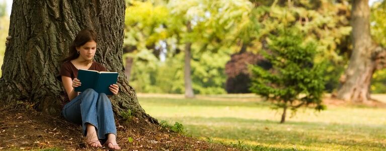 Woman reading under a tree