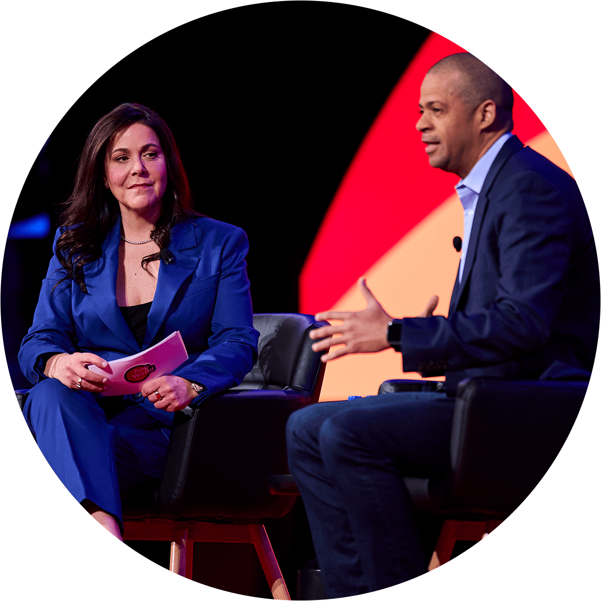 two people in conversation on stage