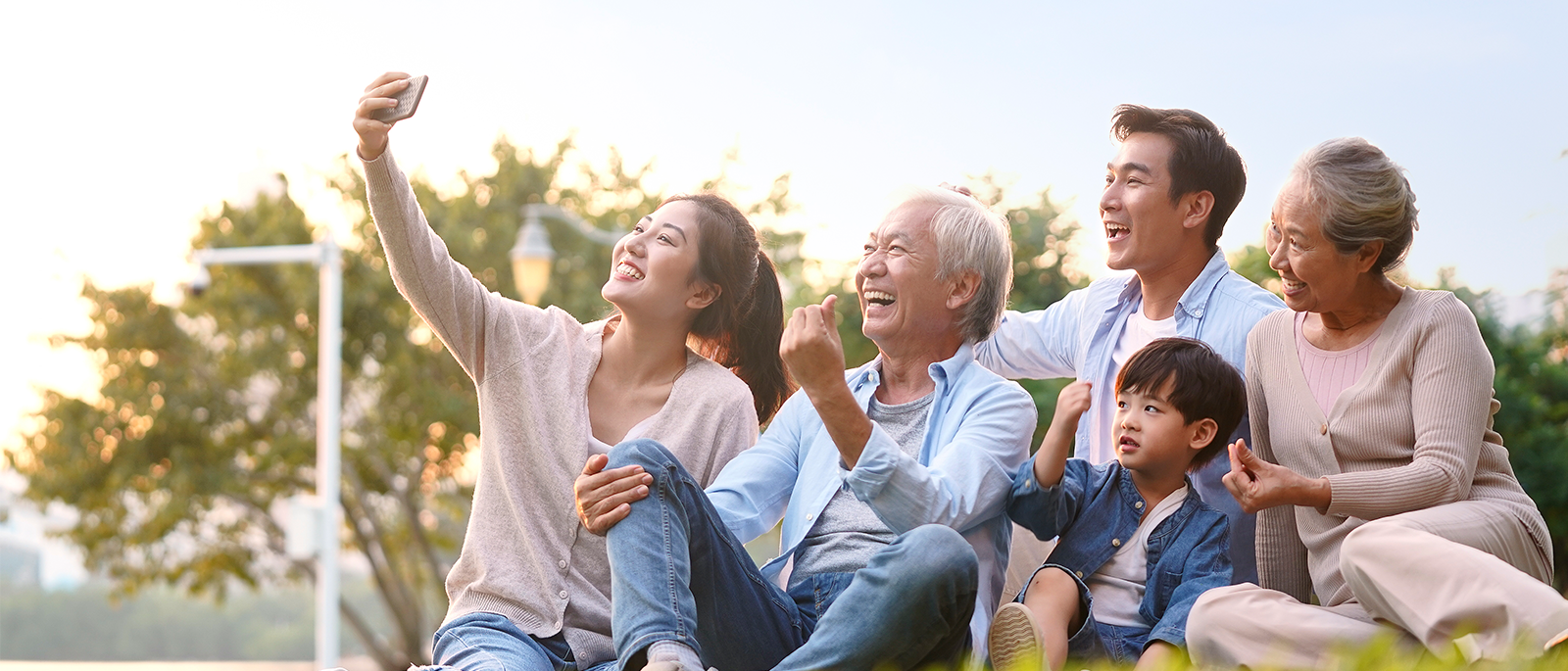 Multigenerational family taking a picture at the park