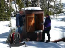 Collecting streamflow data and setting up sediment collectors in March at the Spring Park Parshall flume.