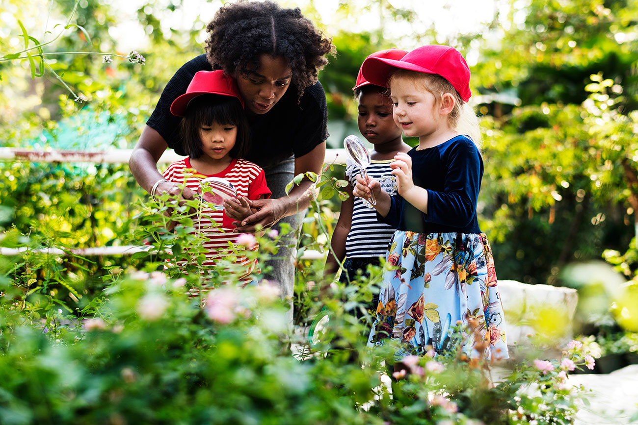 female with two children in garden