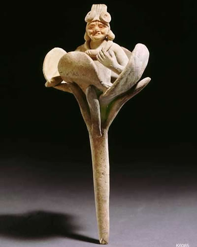 Mesoamerican statue of an old God emerging from a flower.