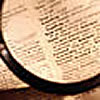 Looking at a dictionary page with a magnifying glass.