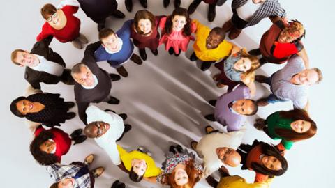 people standing in a circle and looking up at a camera