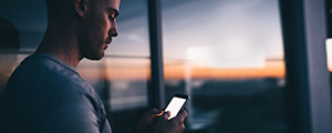 adult male looking on his mobile device for suicide and crisis help