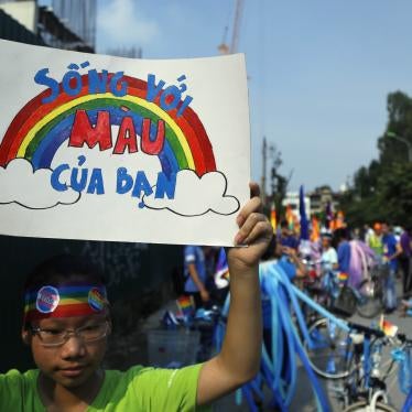 A cyclist holds up a poster reading in Vietnamese, "Shine your true colors," ahead of a bike rally in Hanoi, Vietnam, September 24, 2017. 