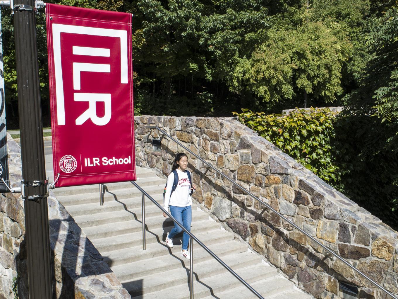 A student walking down the steps outside Ives Hall