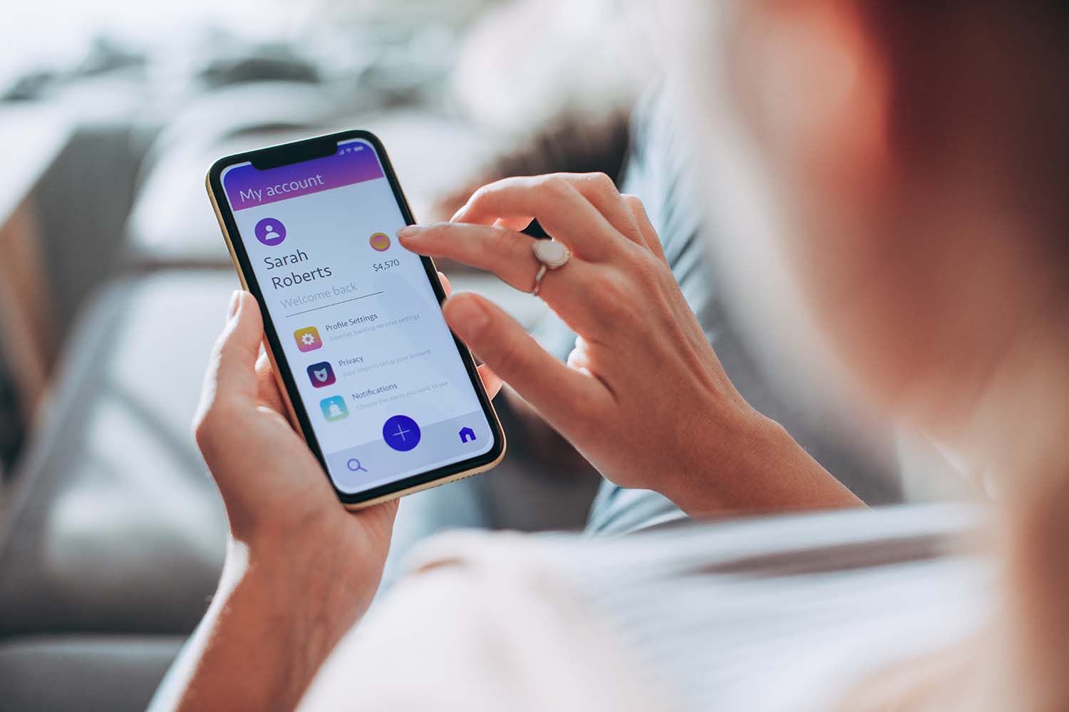 Young lady using a banking app on her phone