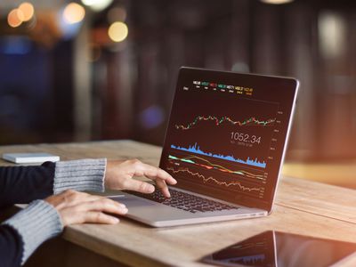 Businessman using laptop for analyzing data stock market, forex trading graph, stock exchange trading online, financial investment concept. All on laptop screen are design up.