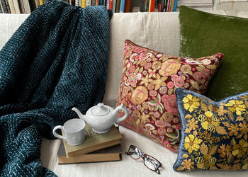 a collection of cozy items: pajamas, incense, robes, mugs, blankets, pillows and puzzles