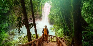 A person looking at a waterfall in Costa Rica