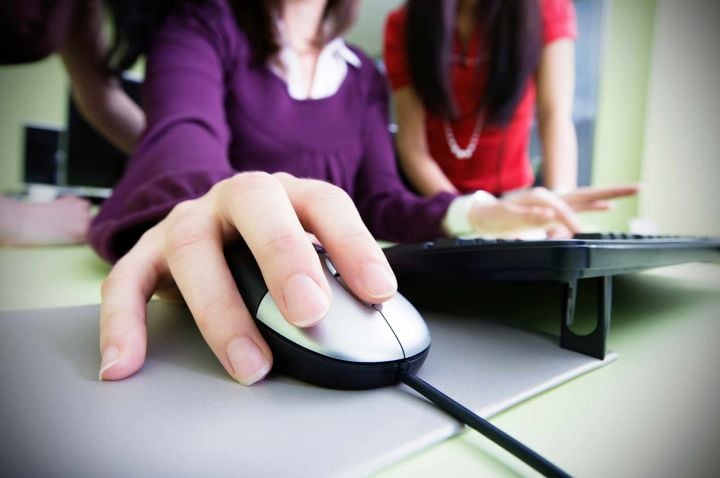 Zoomed up image of female's hand clicking on mouse