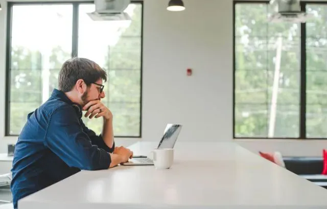 man sitting at computer