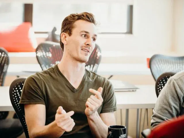 man sitting and smiling