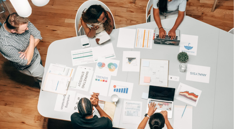 Five individuals in a brainstorming meeting