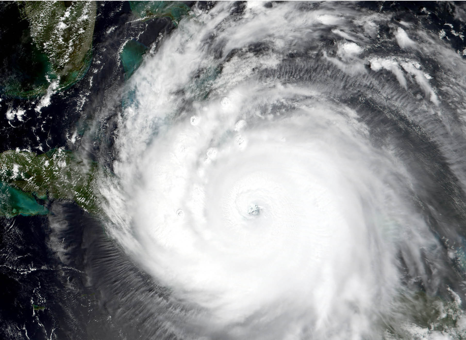 overhead image of hurricane (white) making landfall on a weather map