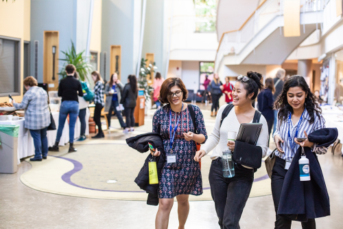 Three students walking together in Kenade Hall