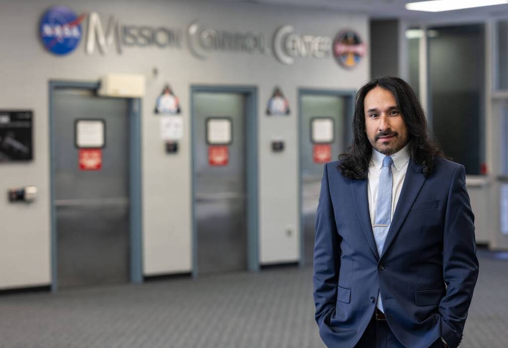 Environmental Portrait of Isidro Reyna in Bldg. 30, in front of the Mission Control Center doors, at NASA's Johnson Space Center in Houston.