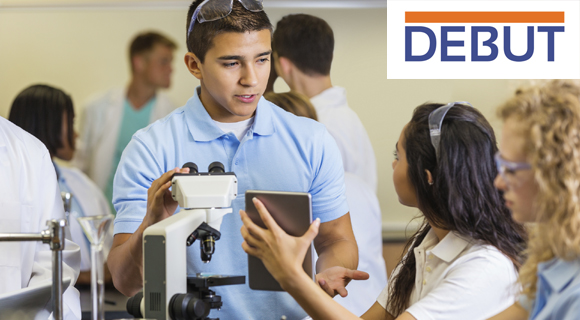 Young man and young woman interact among fellow students in science classroom