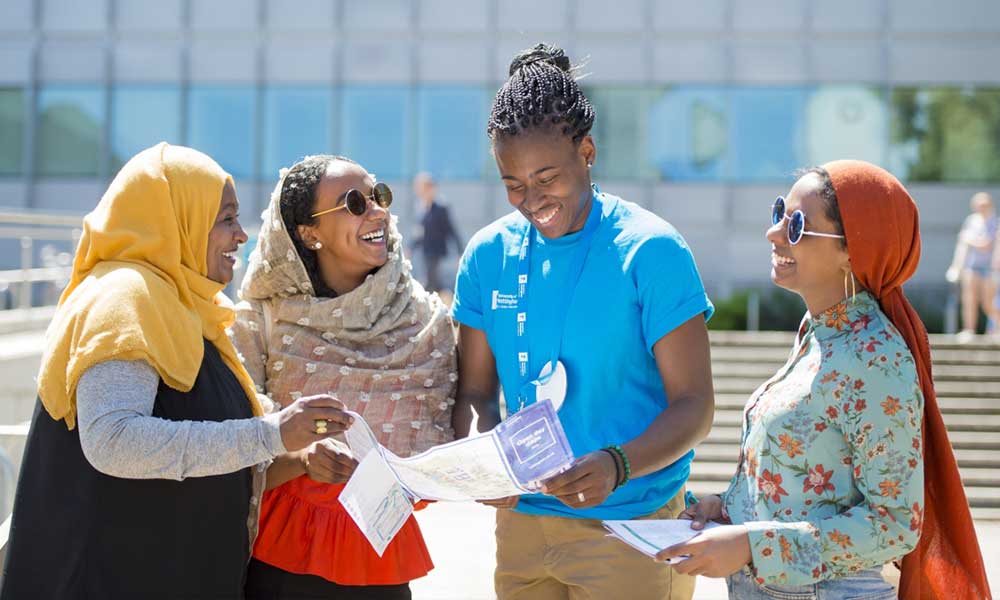 Student helper guiding guests around University Park