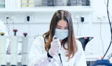 Two scientists in a lab testing samples.