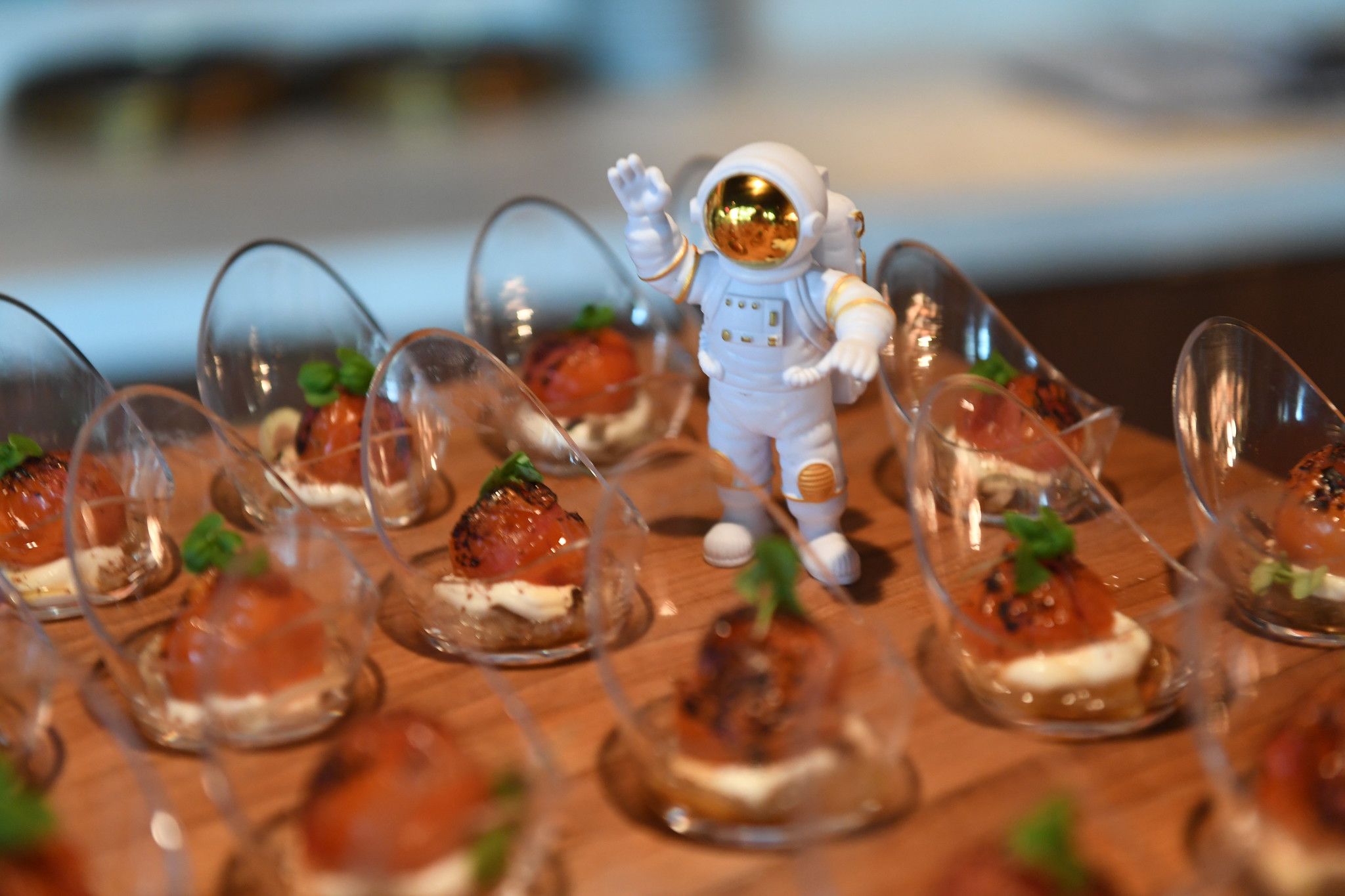 Astronaut toy figure stands among space-themed appetizers