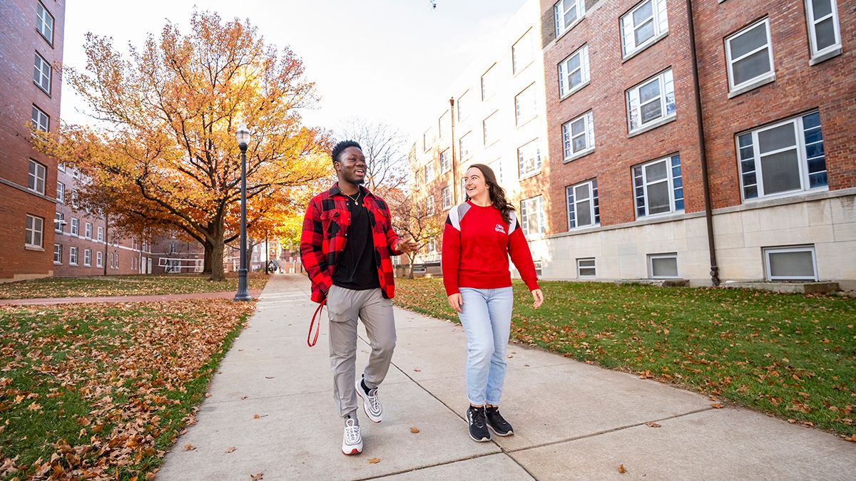 Two students walking on campus.