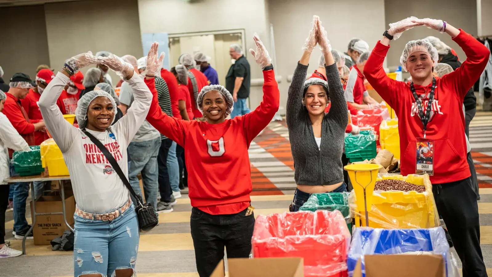 four people pose for o-h-i-o photo