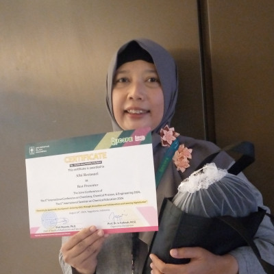 Afni Restasari proudly showing off her best presentation award at IC3PE