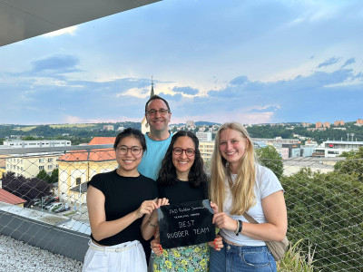 Kirsty Rutherford, Yutong Sun and María Munguía Romero with Prof James Busfield holding their rubber scroll with Prof James Busfield